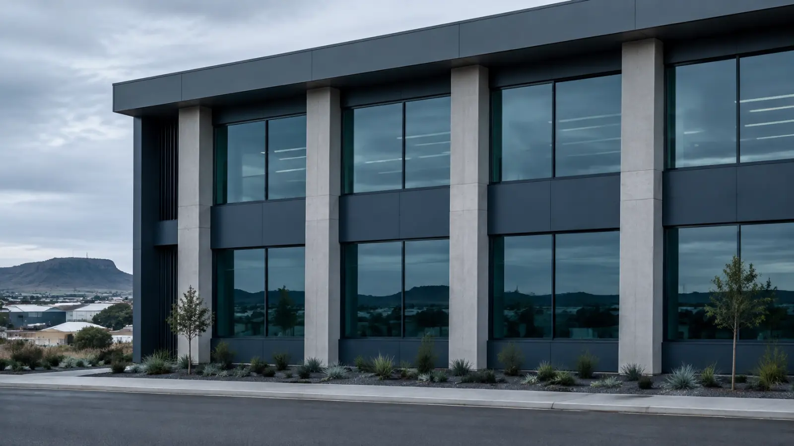 A cool-toned regional commercial building with repeating windows and structural lines